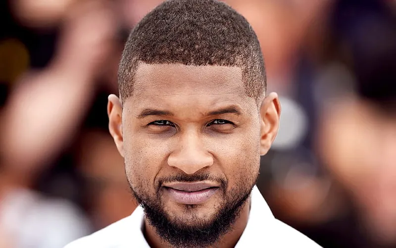 "Infographic of Usher Raymond IV 2026 biography, highlighting career milestones, top albums, Grammy wins, Super Bowl LVIII performance, business ventures, and net worth."